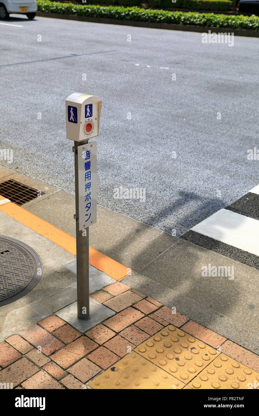 TOKYO JAPAN - MAY 2018 : pedestrian signal button for blind people, japanese text mean 'Press button for acoustic' Stock Photo