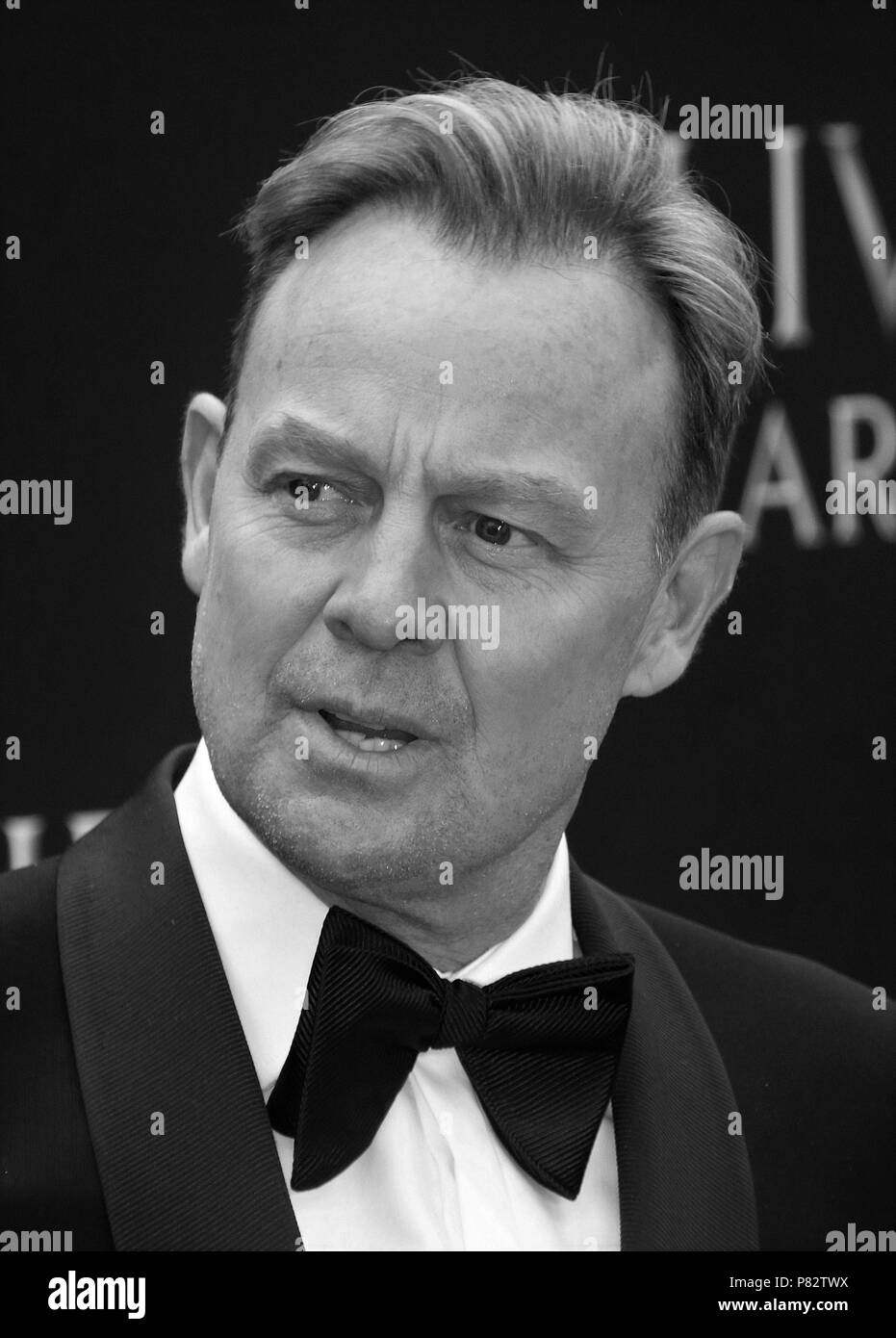 LONDON - APR 08, 2018: ( Image digitally altered to monochrome ) Jason Donovan attends The Olivier Awards at the  Royal Albert Hall Stock Photo