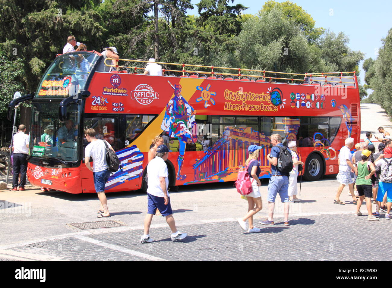 Hop On Hop Off bus taking tourists, visitors and holidaymakers around the historic sites of Athens, GREECE, PETER GRANT Stock Photo