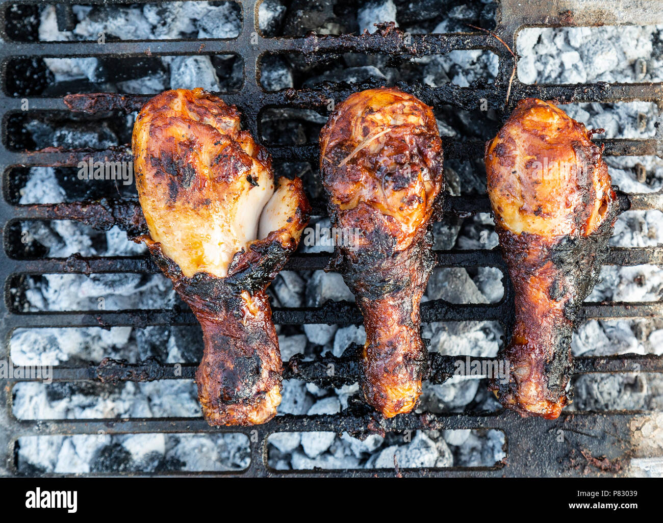 Chicken drumsticks,or Chicken Thighs being cooked on a BBQ, barbecue