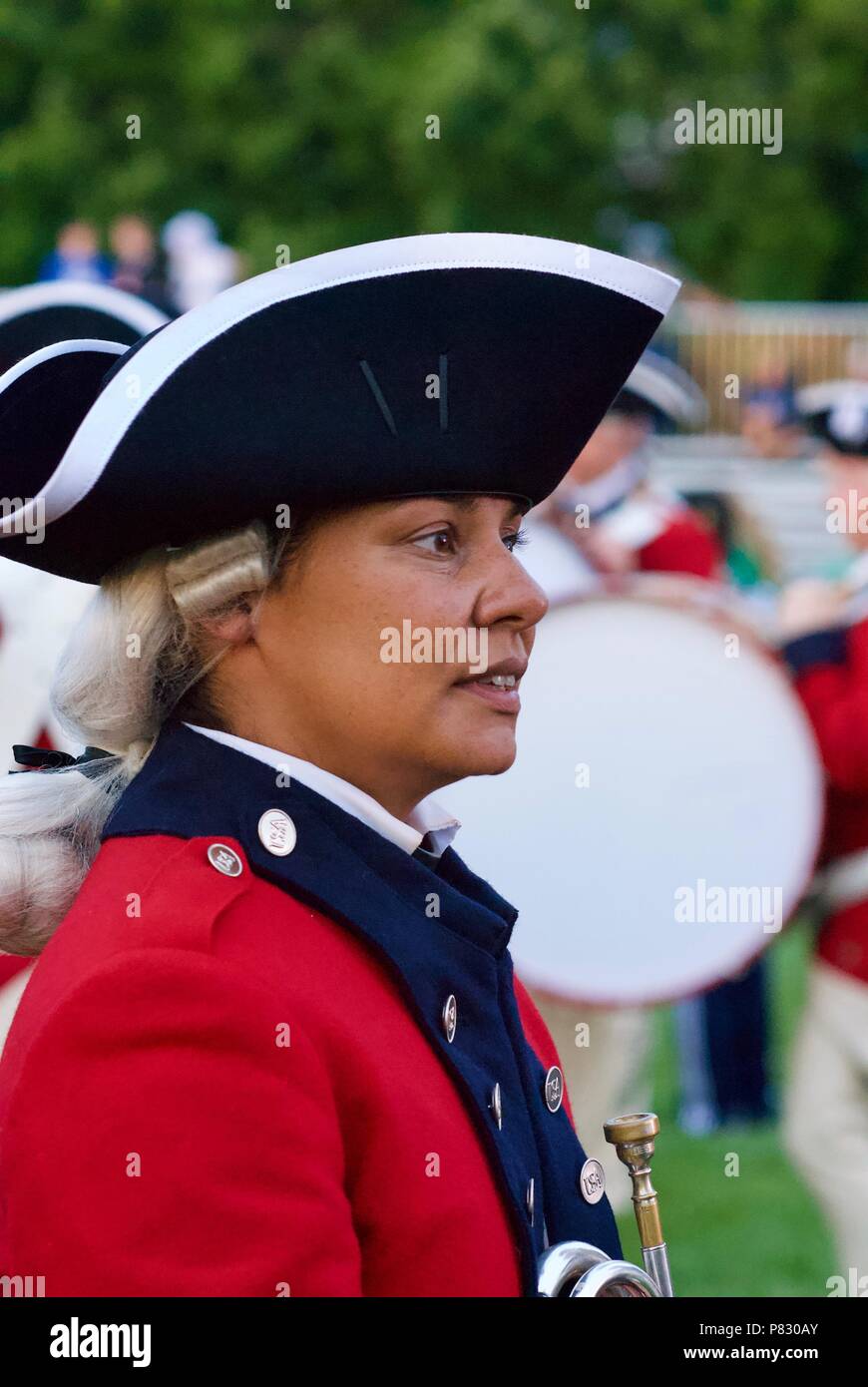 Fort Myer, Virginia, USA - June 13, 2018: A member of the U.S. Army Old Guard Fife and Drum Corps talks with tourists following a Twilight Tattoo. Stock Photo