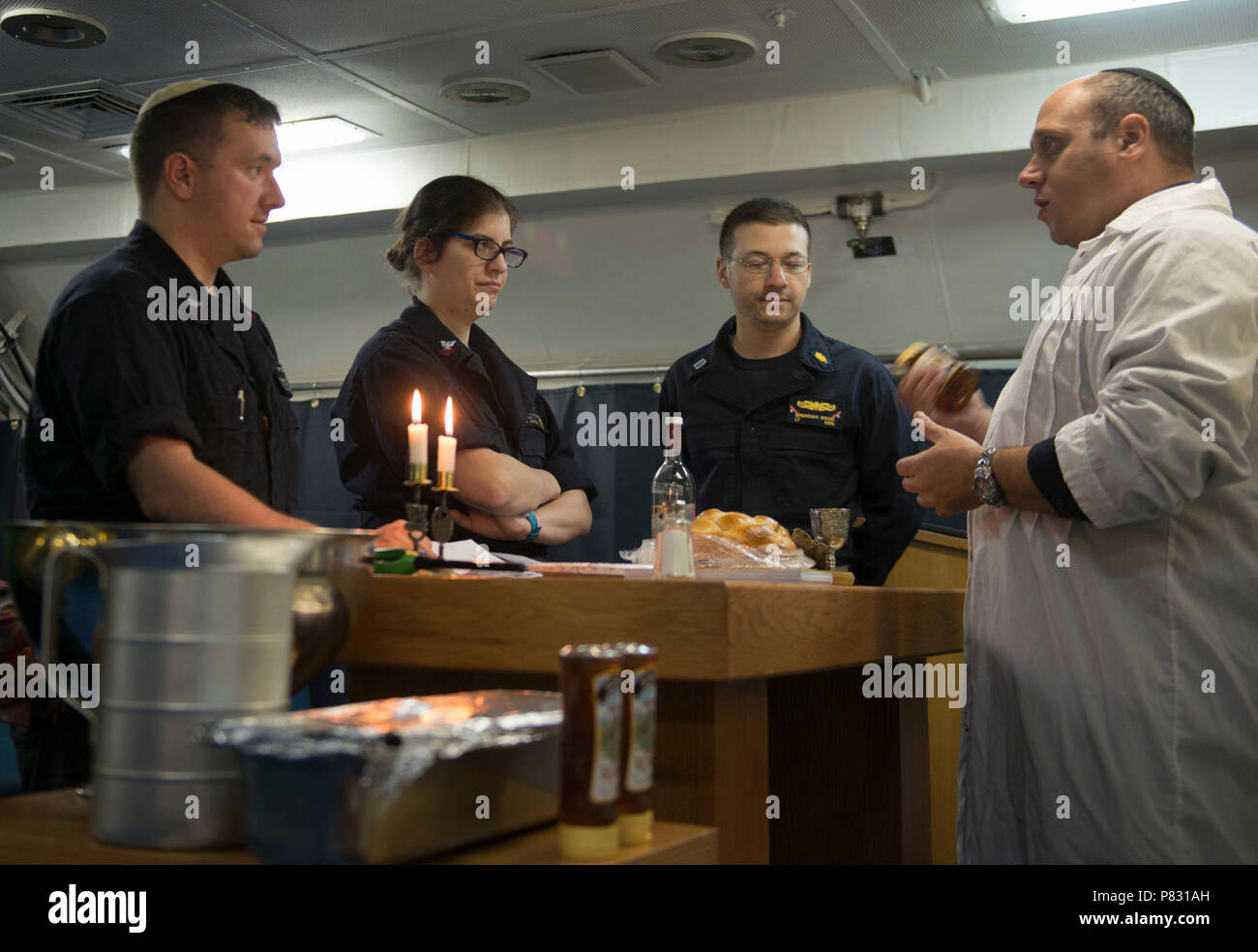 PACIFIC OCEAN (Oct. 2, 2016) Lt. Josh Sherwin, a Navy chaplain, leads a discussion about personal achievements over the previous year during a Rosh Hashanah ceremony aboard USS John C. Stennis (CVN 74). Rosh Hashanah is a two-day celebration of the Jewish New Year that provides an opportunity to reflect on the past year and look ahead in the New Year. Sherwin, one of ten rabbis in the Navy, visited John C. Stennis at sea to provide religious services for the crew during the High Holy Days. John C. Stennis is underway conducting proficiency and sustainment training. Stock Photo