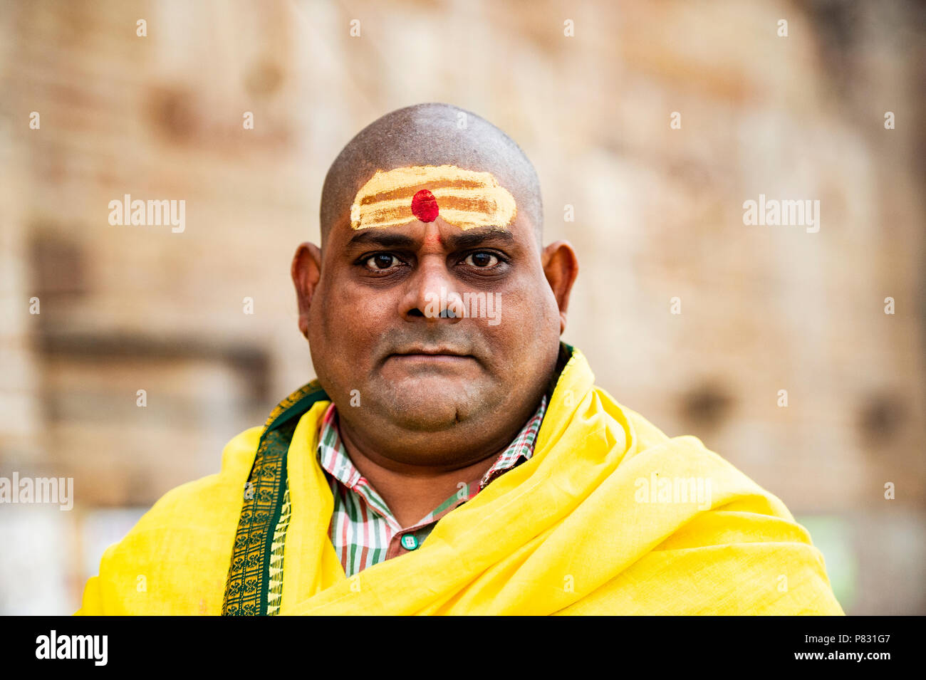 VARANASI - INDIA - 13 JANUARY 2018. Portrait of a shaved man walking on the ghat in Varanasi also known as Benares, India. Stock Photo