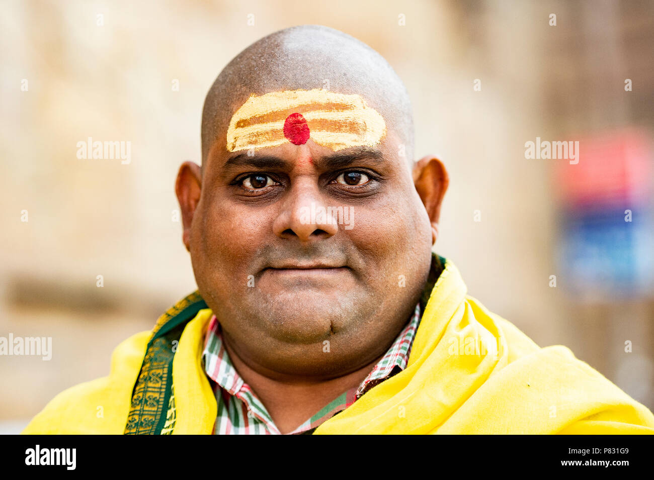 VARANASI - INDIA - 13 JANUARY 2018. Portrait of a shaved man walking on the ghat in Varanasi also known as Benares, India. Stock Photo