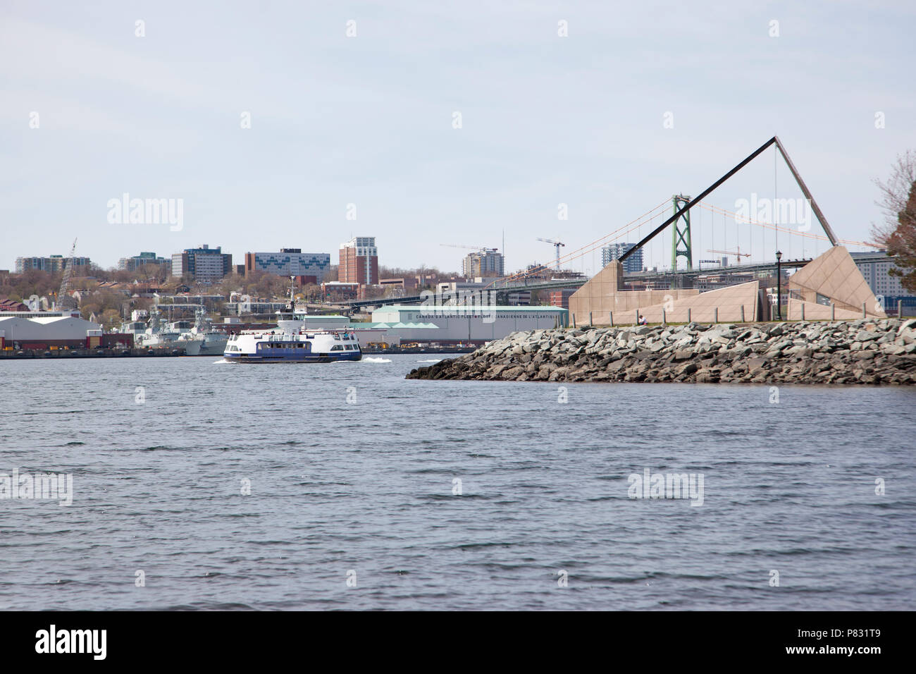 May 12, 2018 - Dartmouth, Nova Scotia: Looking at the Alderney Landing on the Dartmouth waterfront with a ferry crossing and naval shipyard in the bac Stock Photo