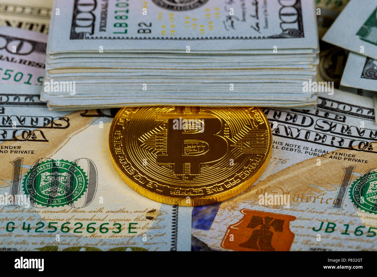 New digital currency, Bitcoin exchange to dollar money banknotes and  accepted to payment. Gold bitcoin coins on one hundred US dollar bills  background Stock Photo - Alamy