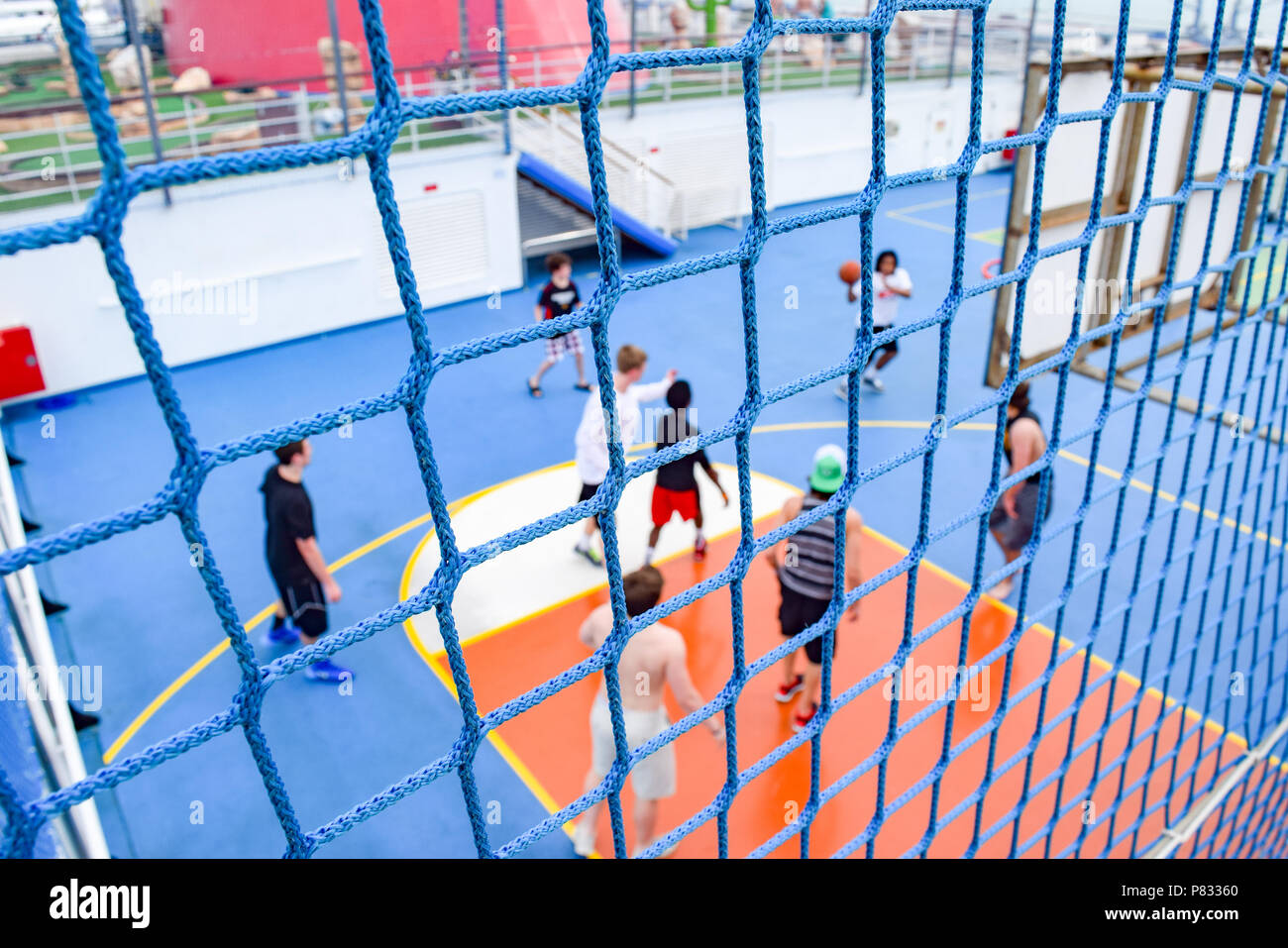 Miami, Florida - March 29 2014: Netting around basketball court and a game in session, onboard the Carnival Liberty cruise ship Stock Photo