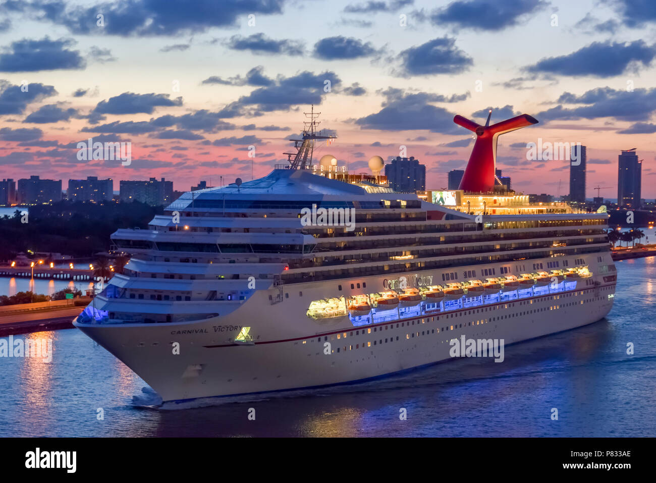 Miami, Florida - April 04 2014: Carnival Victory Cruise Ship sailing at sunrise in the Port of Miami. Stock Photo