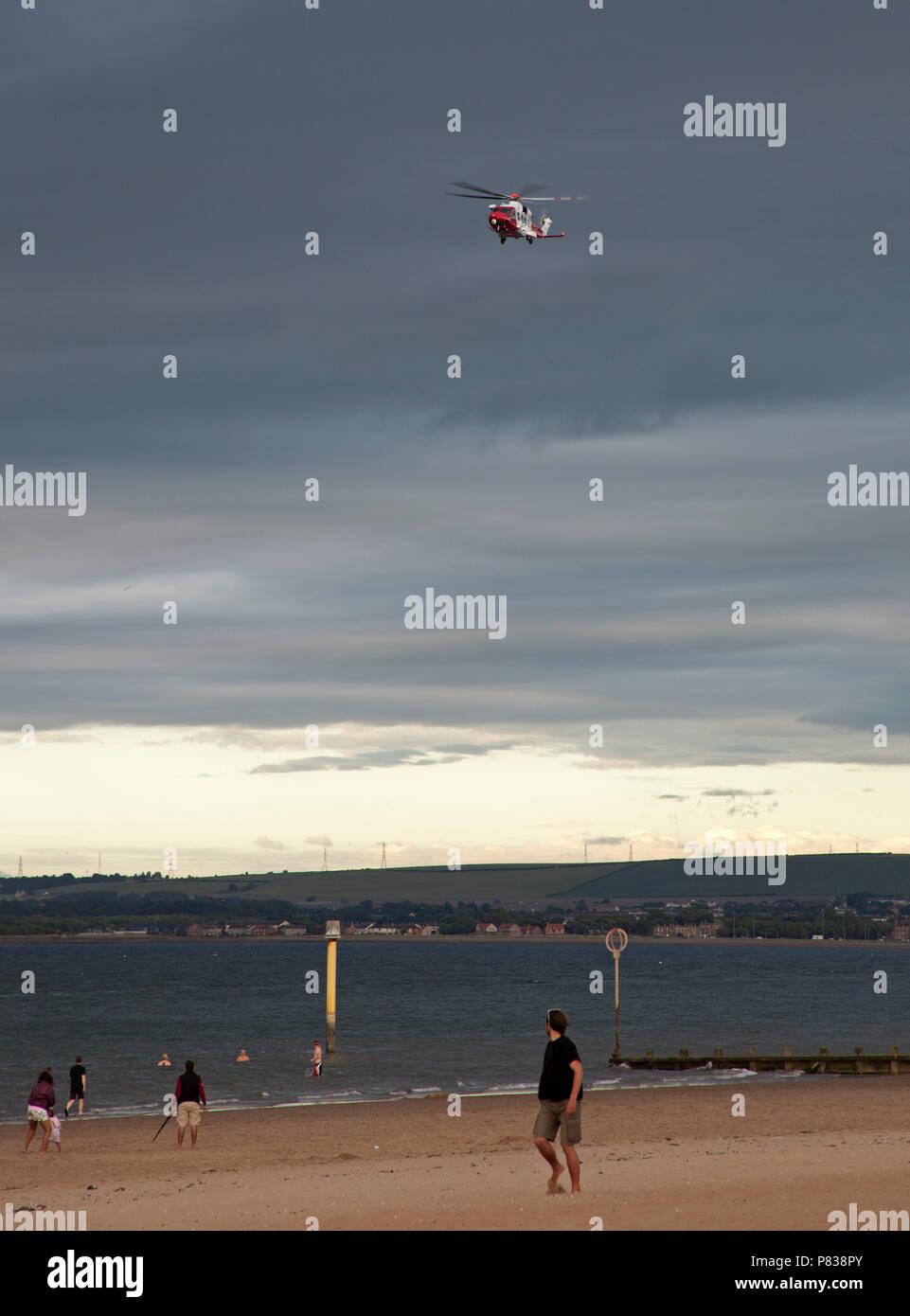 Edinburgh, UK. 08 July 2018. Portobello Beach, Edinburgh, Scotland, UK, between 7pm and 9pm this evening coastguard with four or more vehicles plus one helicopter and a reinforced boat conducting a search of the shoreline of the busy beach, unknown incident Stock Photo