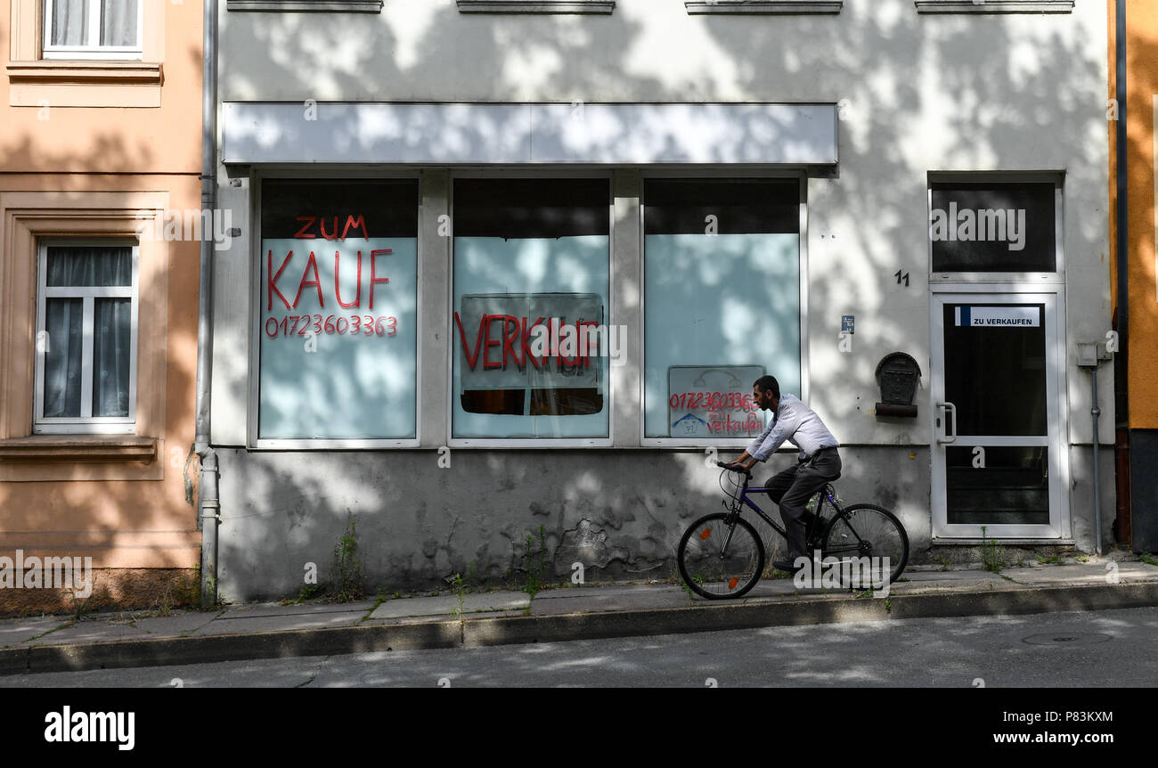 26 June 2018, Germany, Gera: Two signs in a show window read 'Zum Kauf' (for sale) and 'verkaufen' (lit. selling) at the Bauvereinstrasse. Photo: Jens Kalaene/dpa-Zentralbild/dpa Stock Photo