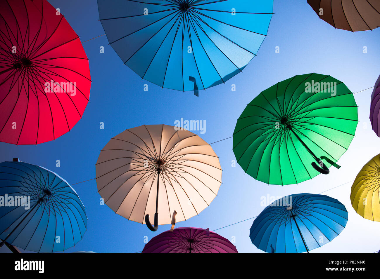 Colorful umbrellas background. Colorful umbrellas in the sky. Street decoration. Stock Photo