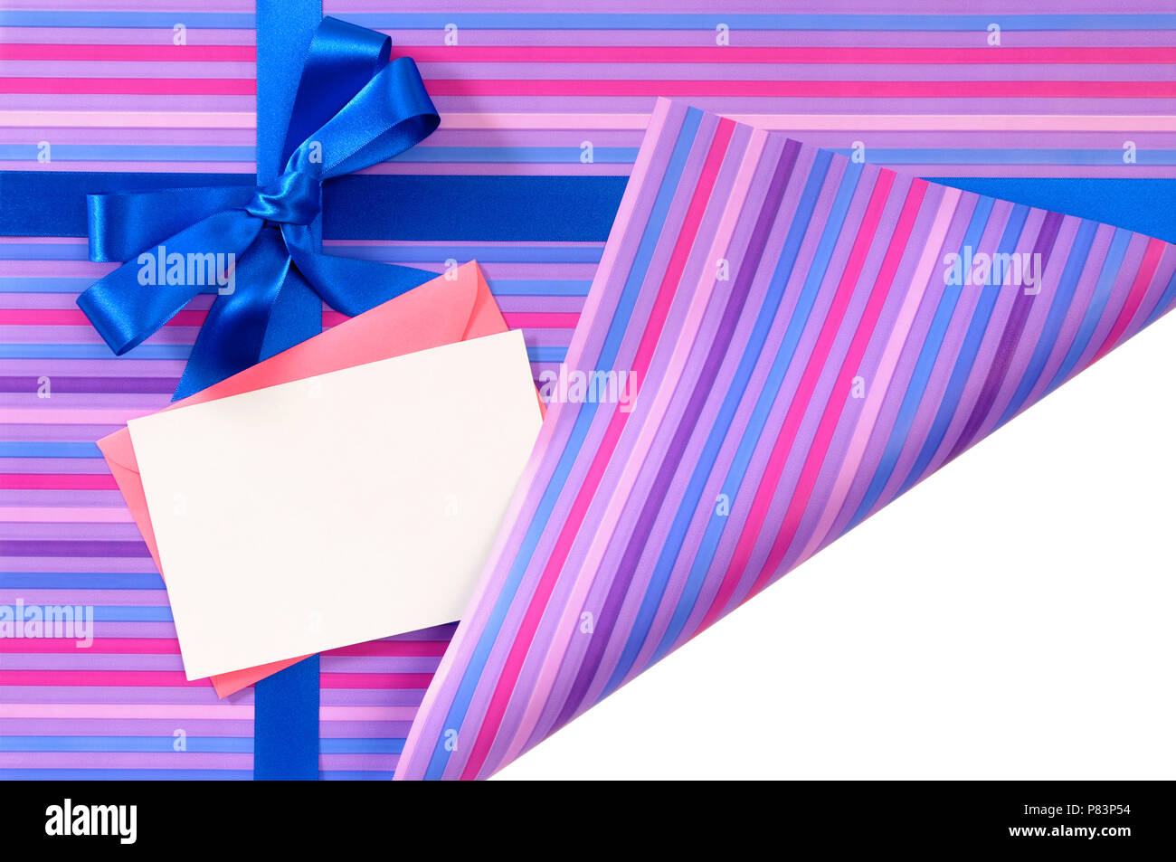 Blue gift ribbon bow on candy stripe wrapping paper, corner folded open revealing white copy space, card and envelope Stock Photo