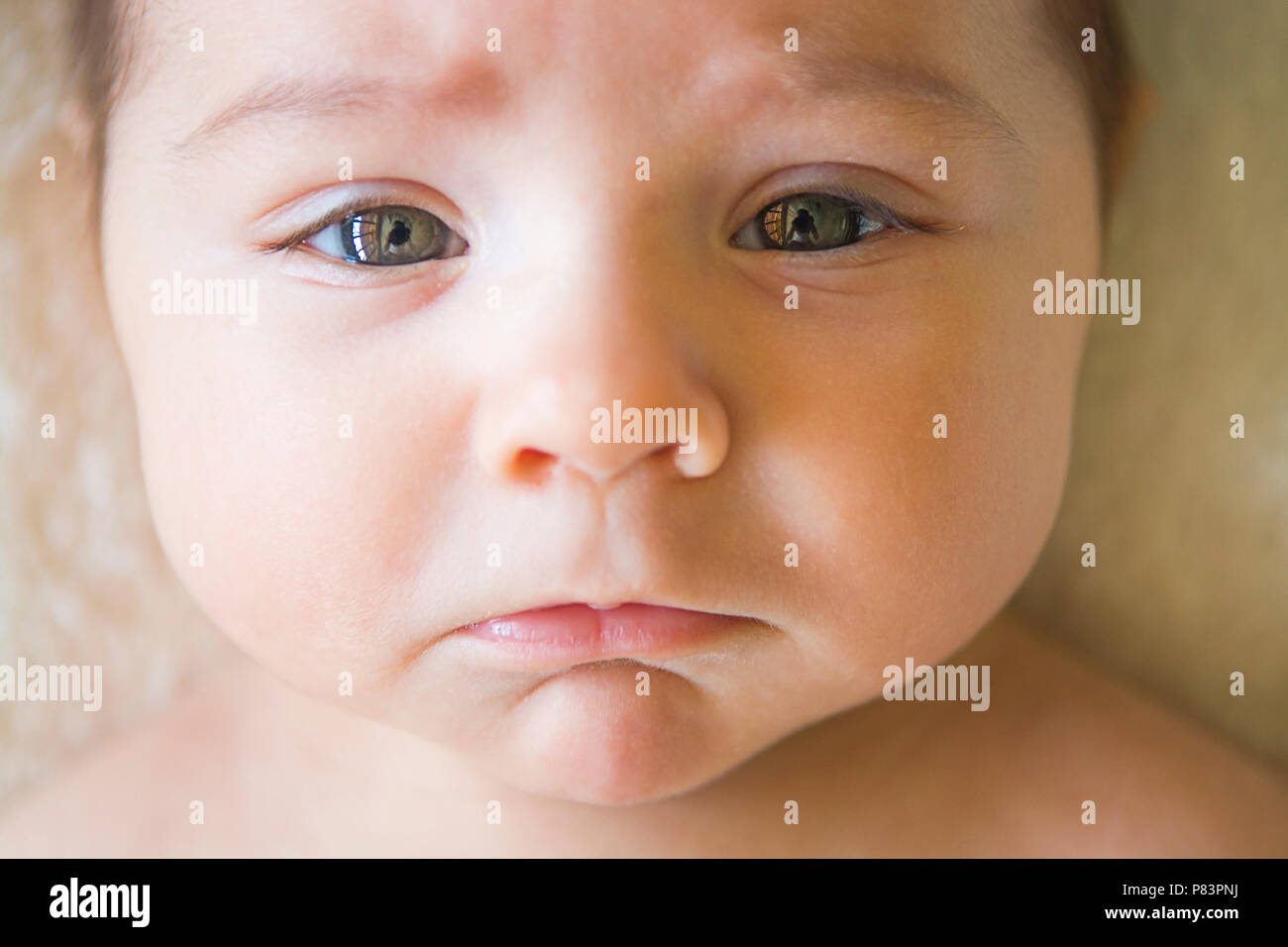 1 month old baby with sad face Stock Photo