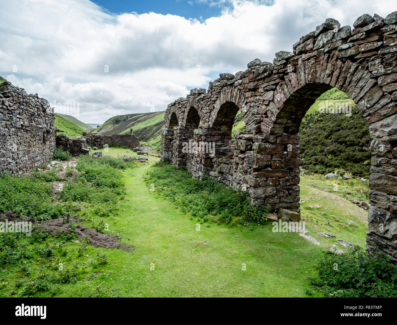 Ruins of Blakethwaite smelt mill peat store remains of the once thriving lead mining industry near Gunnerside in Swaledale in the Yorkshire Dales UK Stock Photo