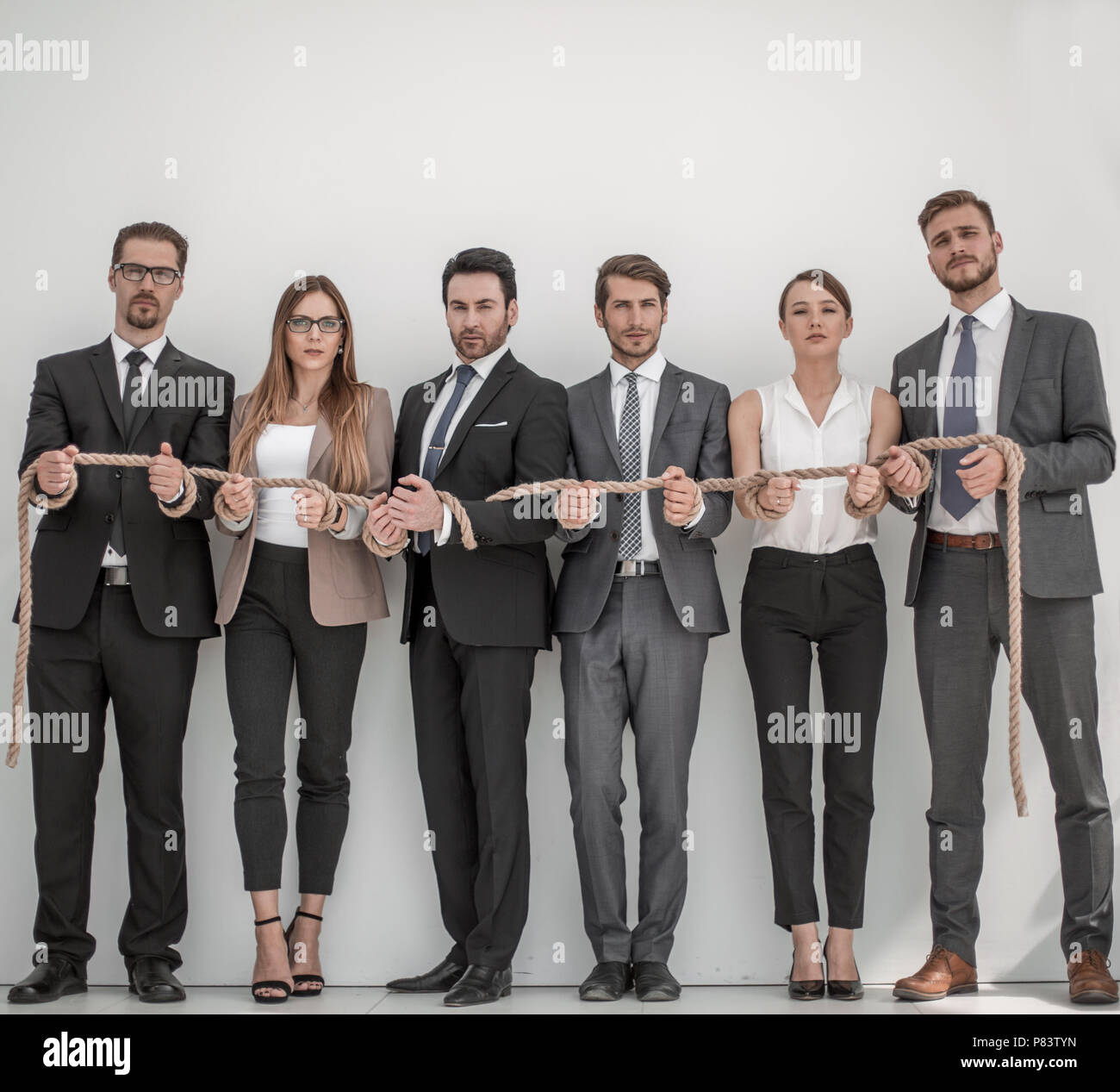group of young people tied with a strong rope Stock Photo - Alamy