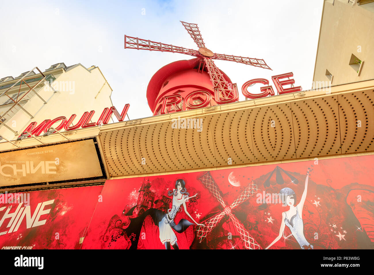 Paris, France - July 1, 2017: signboard of the Moulin Rouge nightclub and historical theater, most famous cabaret attraction of Paris. The Moulin Rouge is a symbol of Pigalle District. Stock Photo