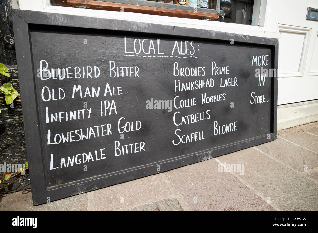 handwritten sign for local ales outside a small off licence windermere lake district cumbria england uk Stock Photo