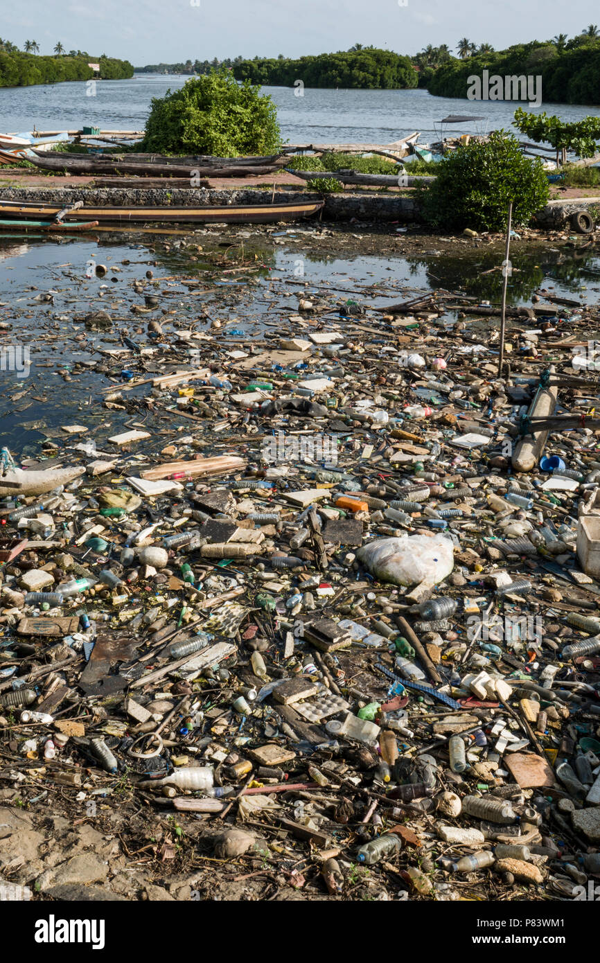 Plastic bottles, polystyrene and other assortment of trash completely