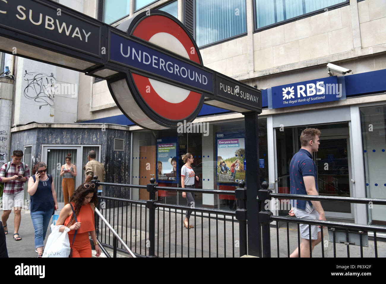 People Walk Past The Branch Of The Royal Bank Of Scotland Bank Next To The Notting Hill Gate Tube Station Stock Photo Alamy