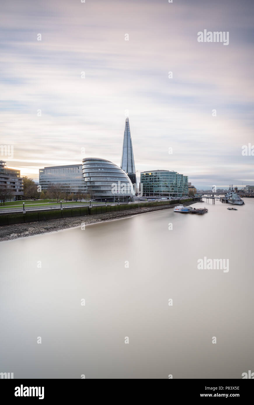 Long exposure of the view from Tower Bridge to London Bridge down the River Thames with The Shard, City Hall and HMS Belfast Stock Photo