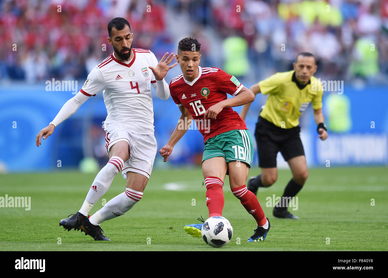 SAINT PETERSBURG, RUSSIA - JUNE 15: Roozbeh Cheshmi of IR Iran competes with Amine Harit of Morocco during the 2018 FIFA World Cup Russia group B match between Morocco and Iran at Saint Petersburg Stadium on June 15, 2018 in Saint Petersburg, Russia. (Photo by Lukasz Laskowski/PressFocus/MB Media) Stock Photo