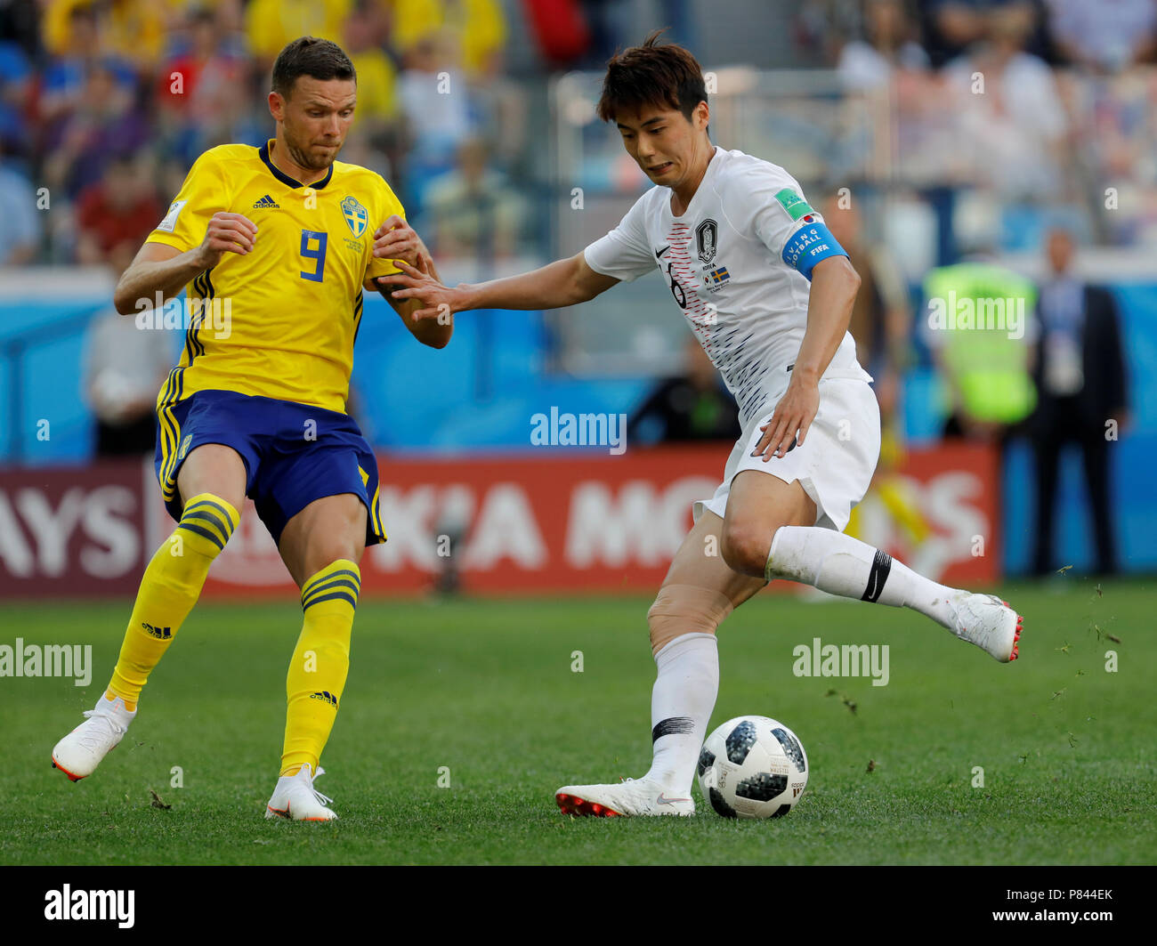 NIZHNY NOVGOROD, RUSSIA - JUNE 18: Marcus Berg (L) of Sweden national team and Sungyueng Ki of Korea Republic national team vie for the ball during the 2018 FIFA World Cup Russia group F match between Sweden and Korea Republic at Nizhny Novgorod Stadium on June 18, 2018 in Nizhny Novgorod, Russia. Stock Photo