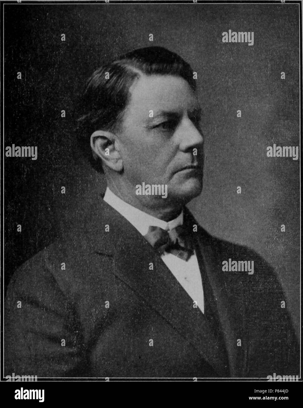 Black and white portrait print of the Honorable Edward Wallis Hoch, Governor of Kansas, depicted in profile, from the chest up, wearing a dark jacket and a bowtie, with a serious expression on his face, 1908. Courtesy Internet Archive. () Stock Photo