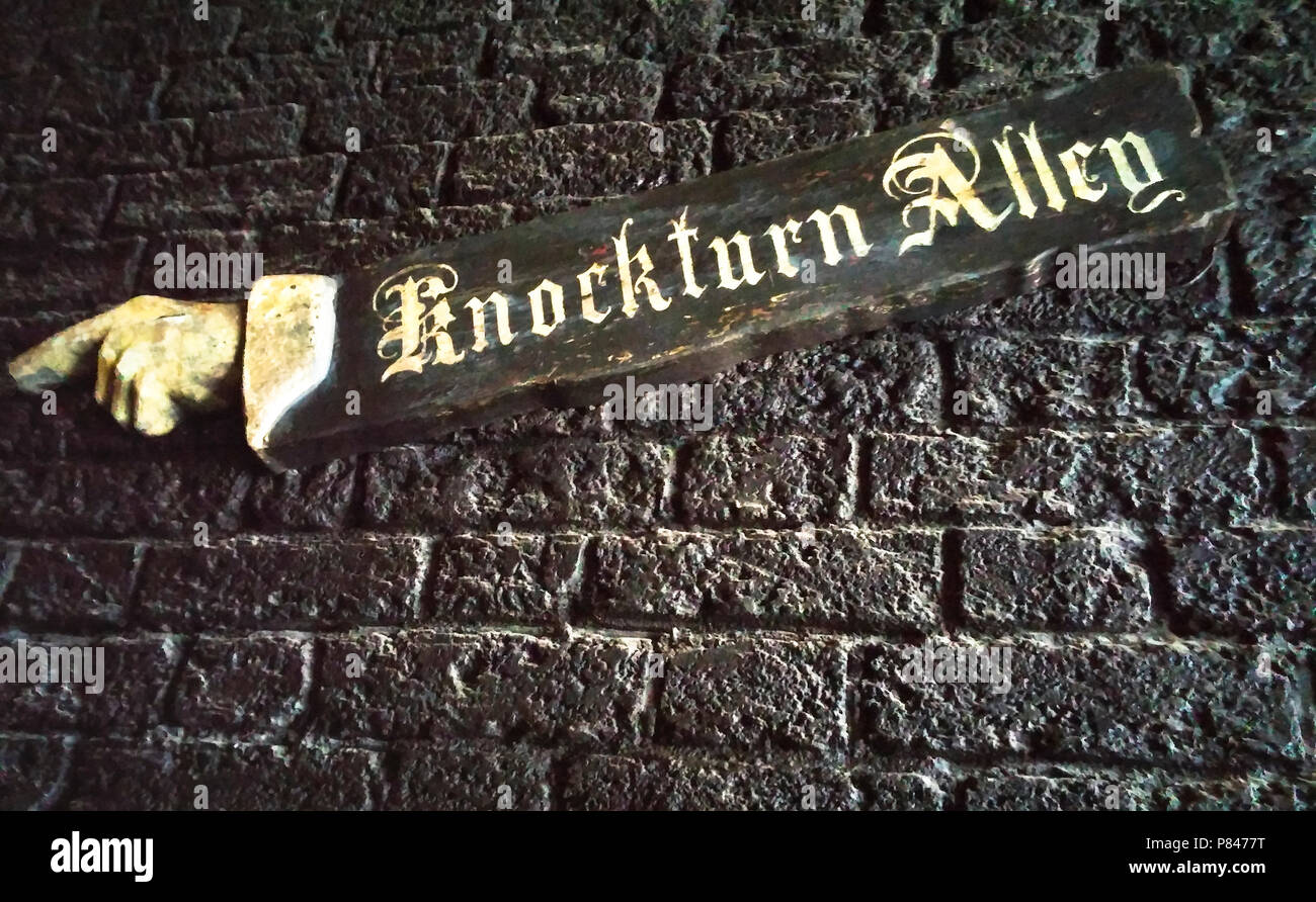 Knockturn Alley sign in the Wizarding World of Harry Potter. The sign points the way with a long arm and pointing hand, leading to the darker HP world Stock Photo
