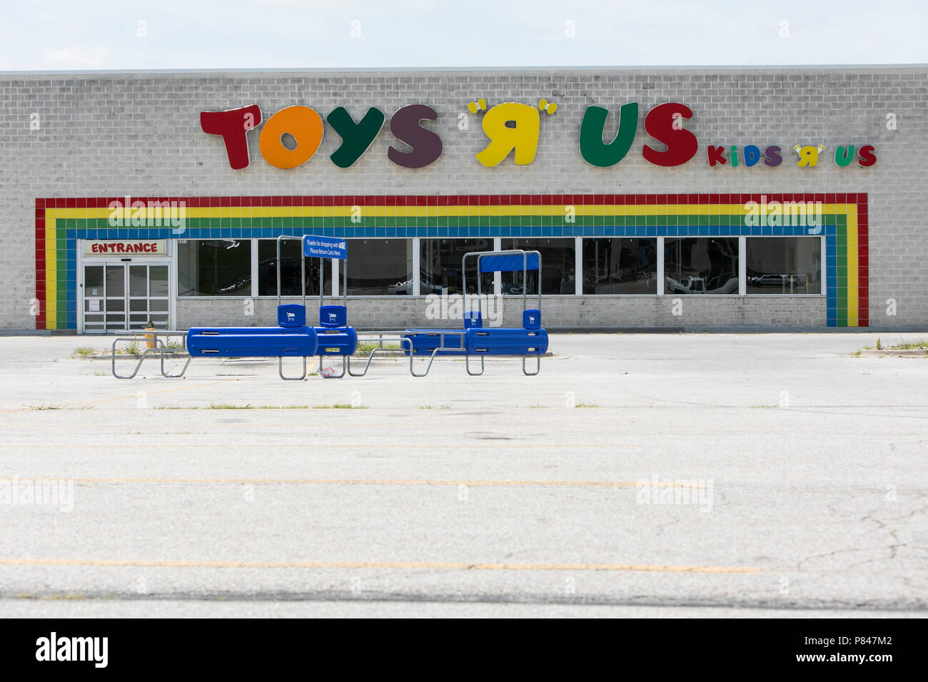 A logo sign outside of a now closed ToysRUs retail store in Des