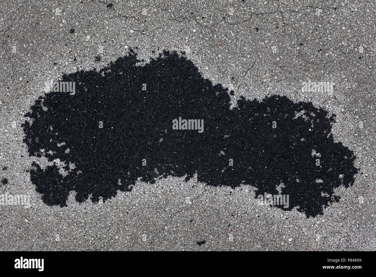 Closeup view of old obsolete asphalt, black and gray gravel details. Stock Photo