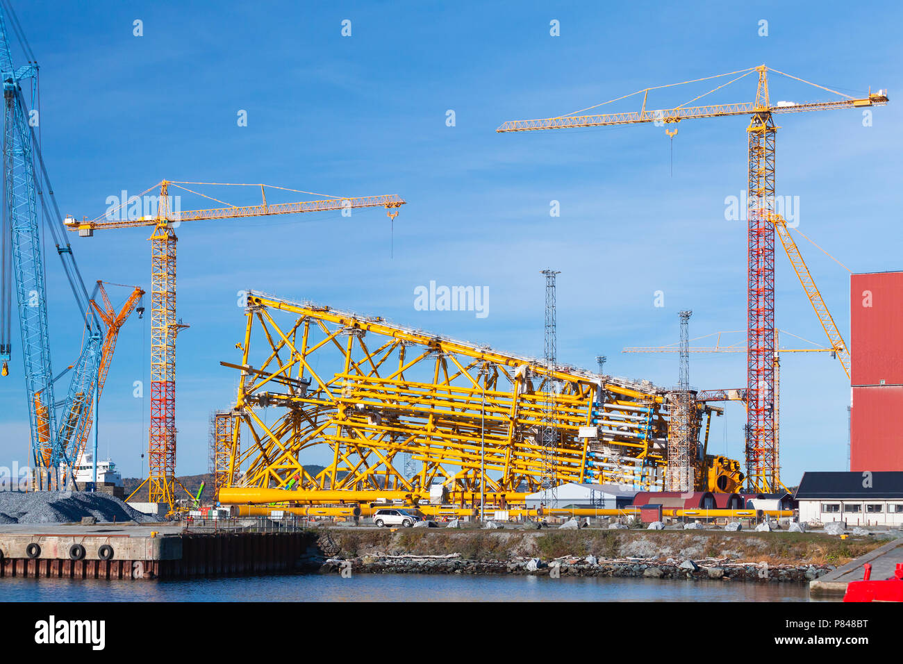 Oil production platform is under construction. Industrial landscape with cranes. Verdal, Norway Stock Photo