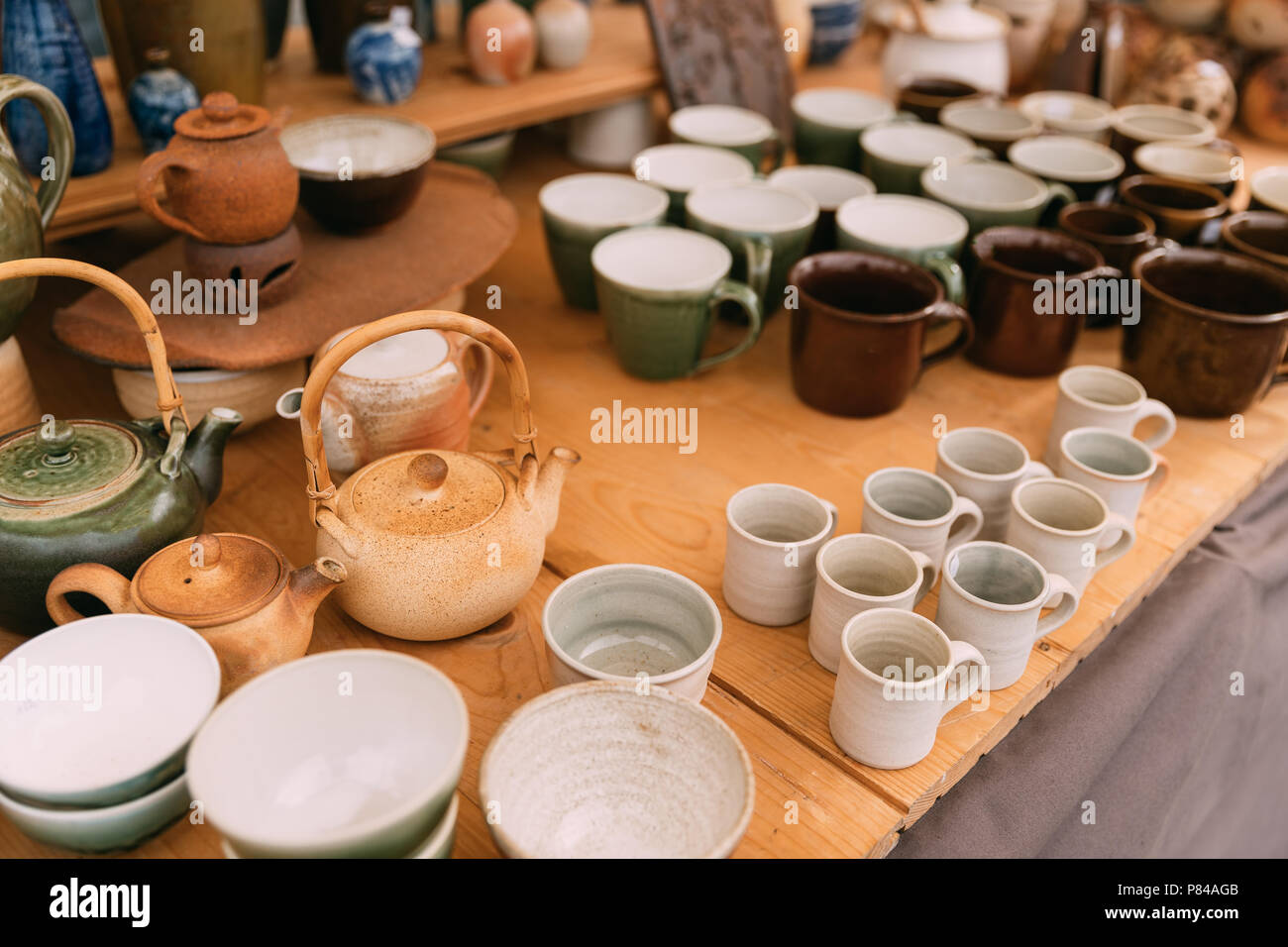 Ceramic Clay Crafts. Ceramic Dishware In Market. Bowls, Kettle, Cups Of Different Sizes, Colors And Shapes. Stock Photo