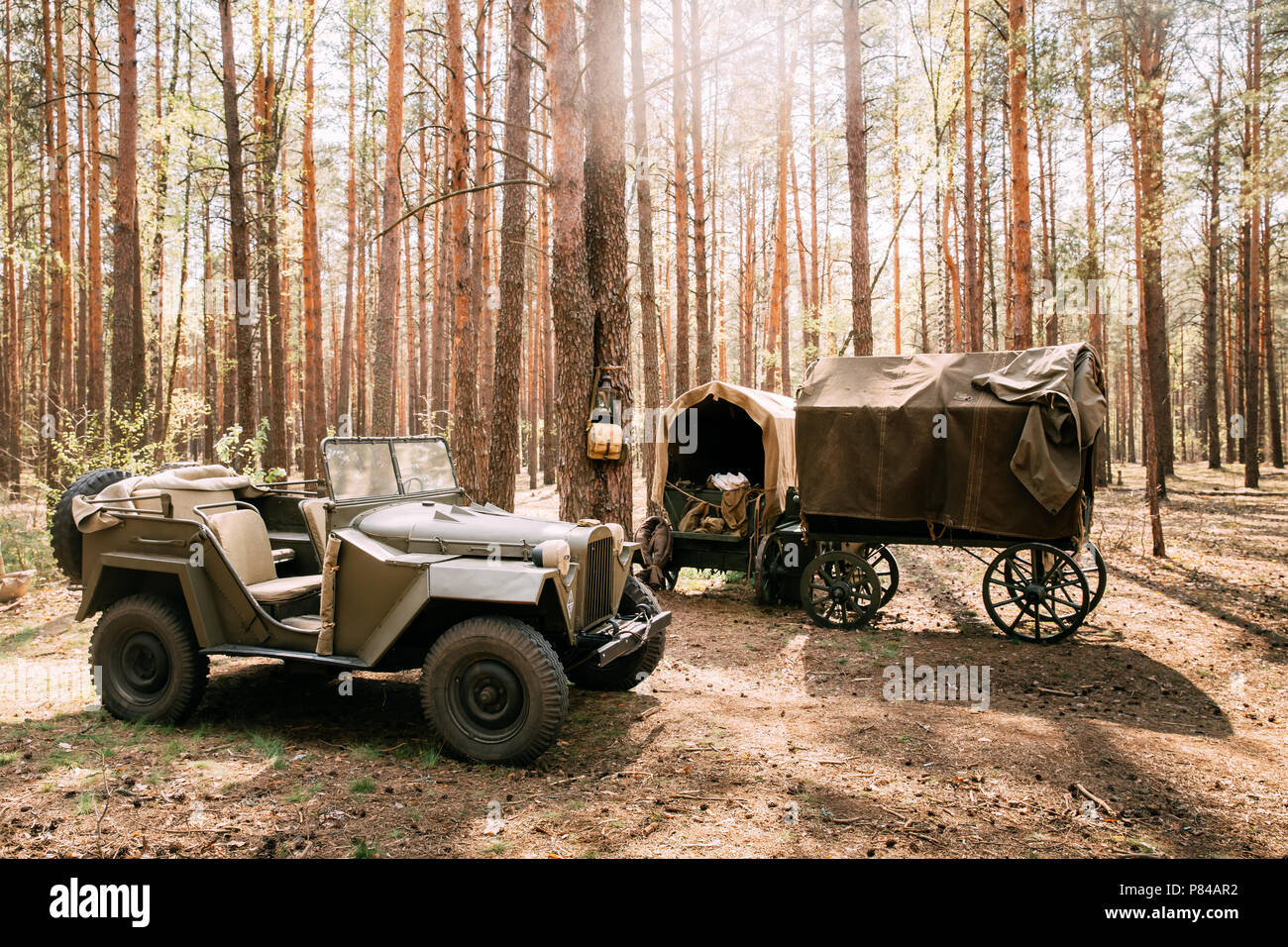 Russian Soviet World War II Four-wheel Drive Army Truck Gaz-67 Car And Peasant Carts In Forest. WWII Equipment Of Red Army. Stock Photo