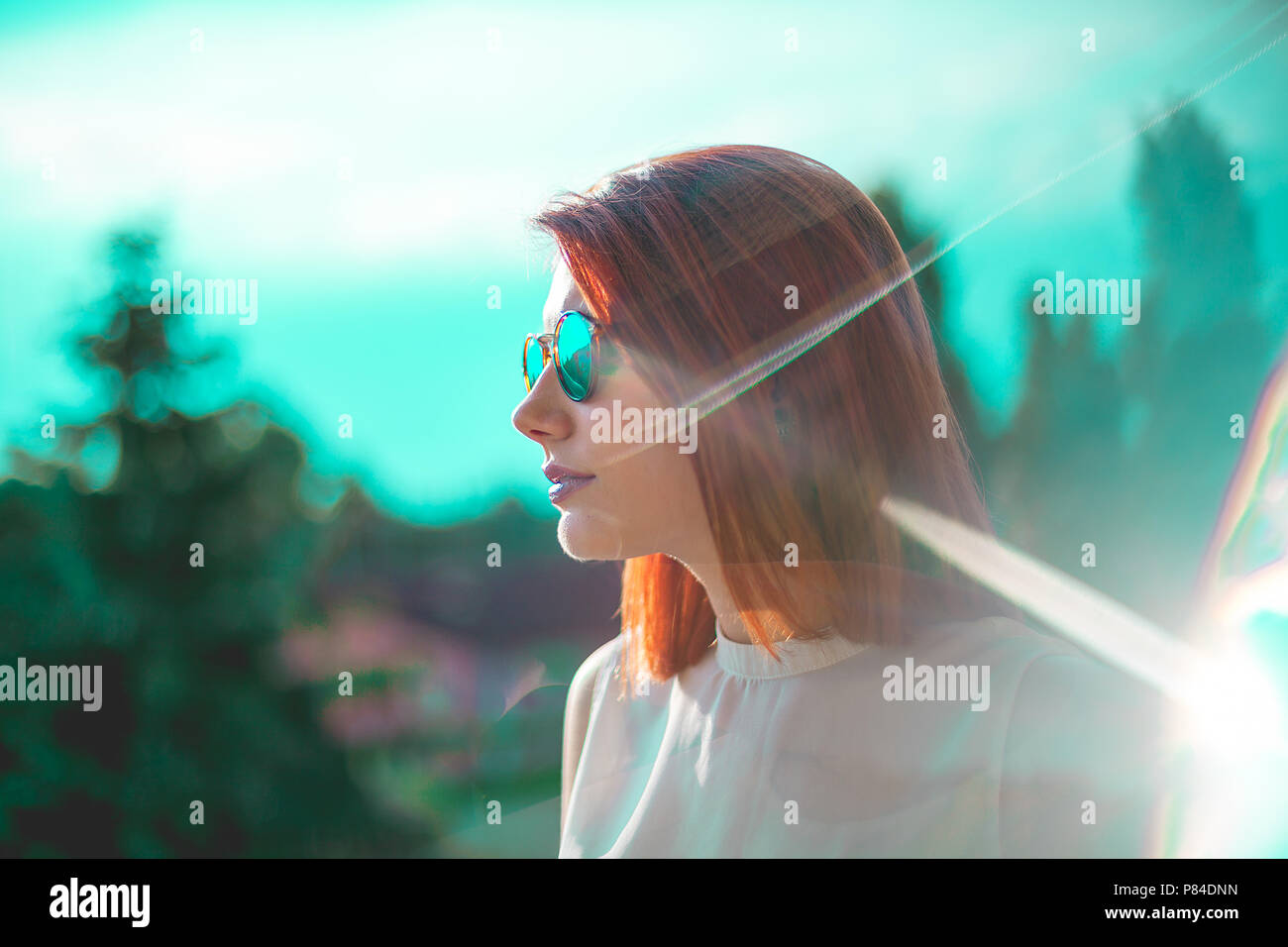 Portrait Of Beautiful Redhair Woman Wearing Glasses Teal And