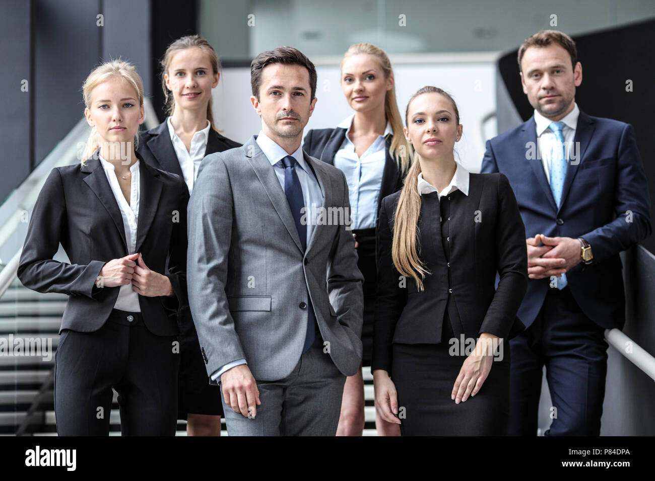Portrait of successful business people team standing together in modern ...