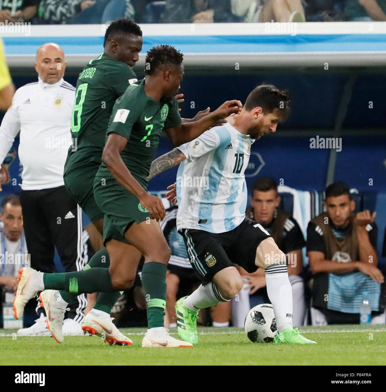 SAINT PETERSBURG, RUSSIA - JUNE 26: Argentina national team head coach Jorge Sampaoli (L) looks as Lionel Messi (R) vies for the ball with Ahmed Musa (N7) and Oghenekaro Etebo of Nigeria national team during the 2018 FIFA World Cup Russia group D match between Nigeria and Argentina at Saint Petersburg Stadium on June 26, 2018 in Saint Petersburg, Russia. (MB Media) Stock Photo