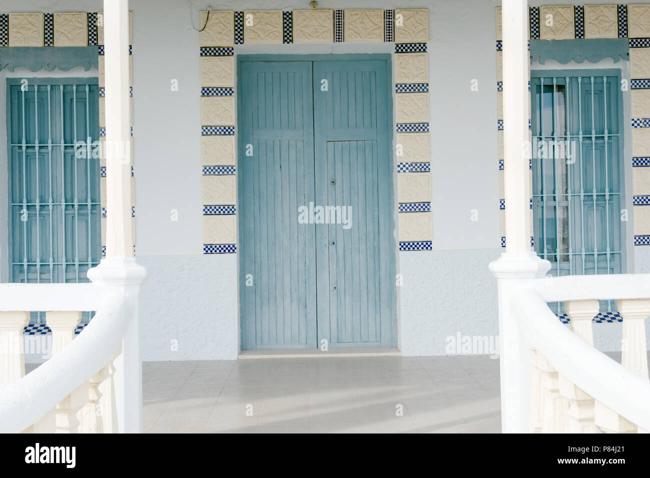 House with white walls and light blue door and windows Stock Photo - Alamy