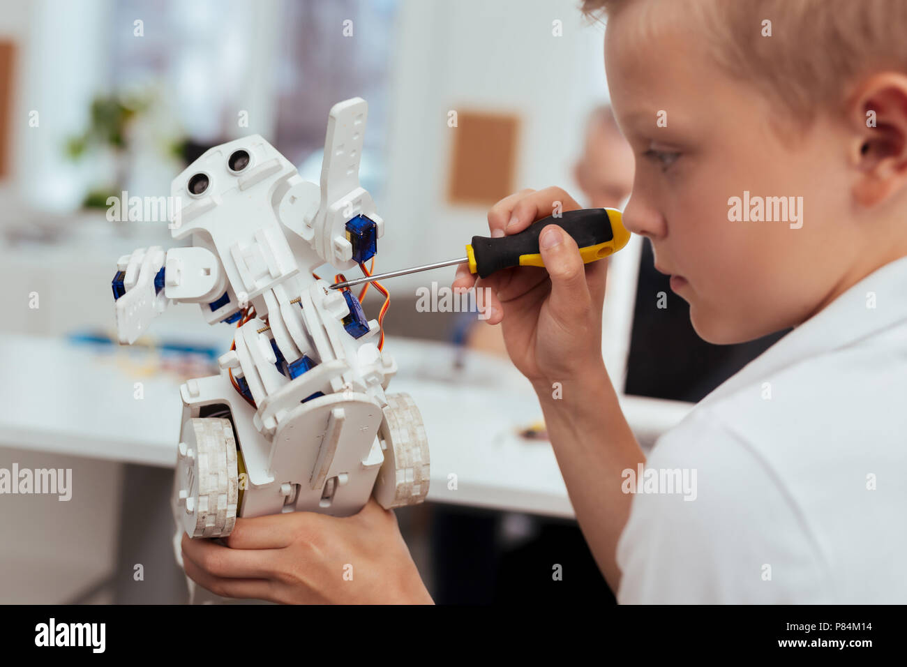 Smart blonde boy being interested in technology Stock Photo