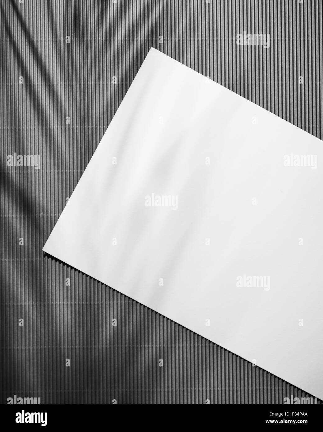 White Paper Pad On Dark Wooden Table With Shadows And Copy Space Top