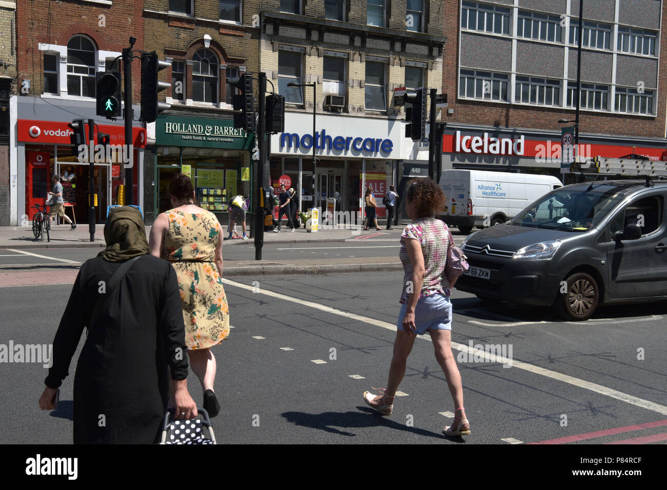 People walk past a branch of the specialist retailer Mothercare on the Holloway Road in North London Stock Photo