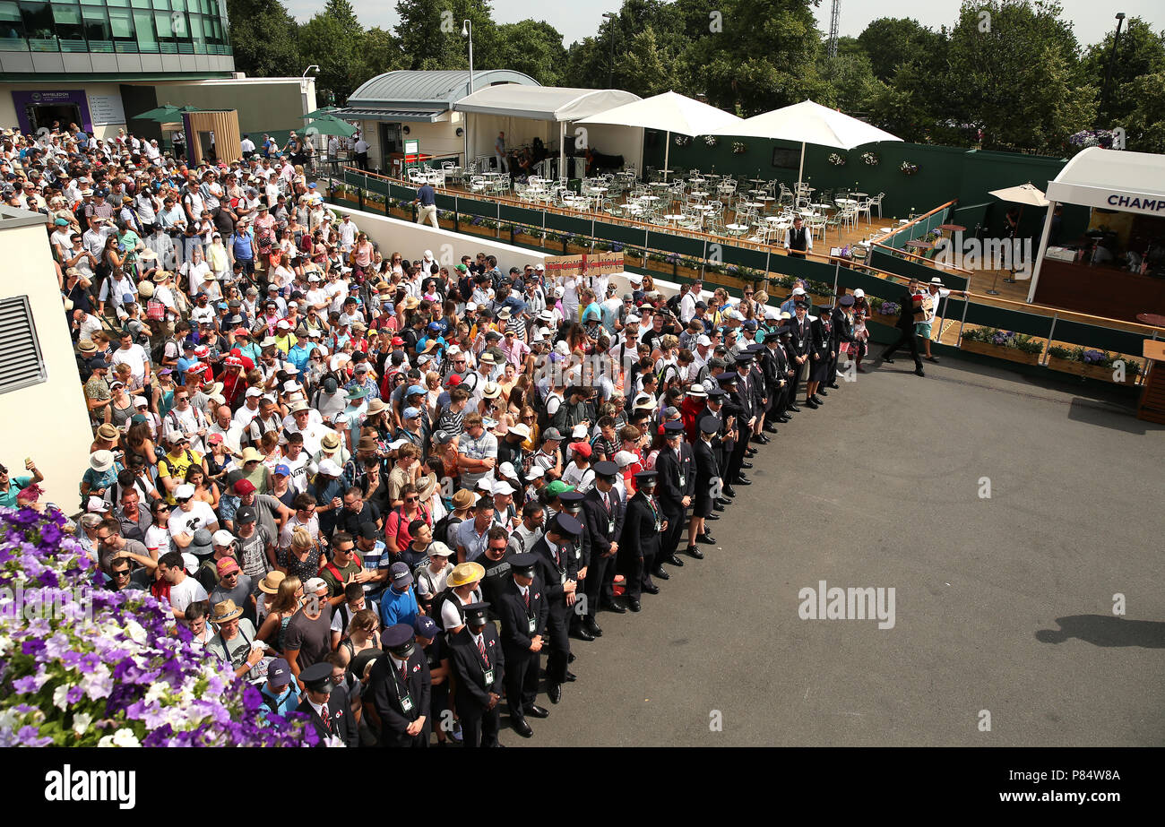 Spectators are led into the grounds on day seven of the Wimbledon Championships at the All England Lawn Tennis and Croquet Club, Wimbledon. Stock Photo
