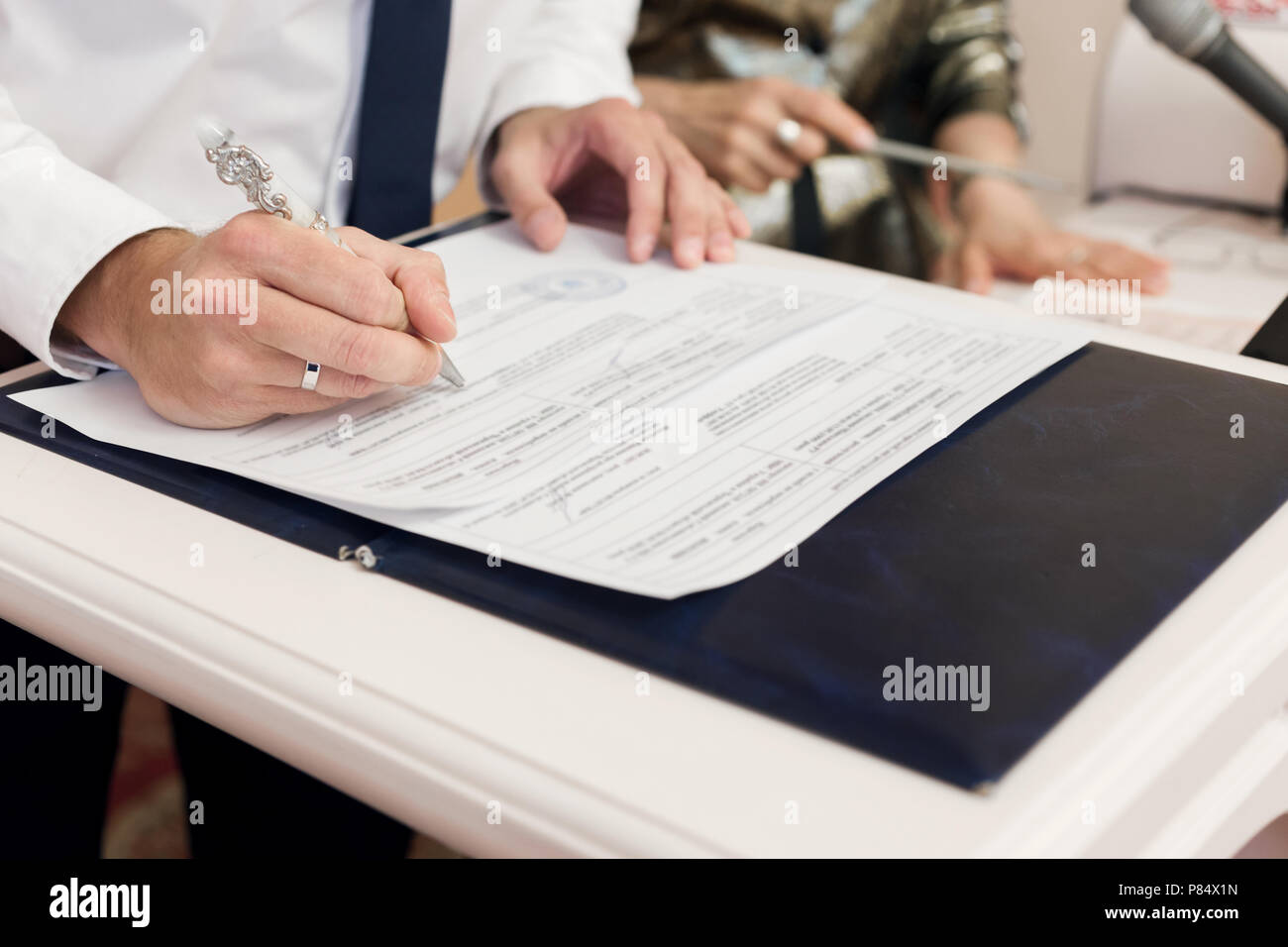Man leaving signatures registration of marriage close up Stock Photo