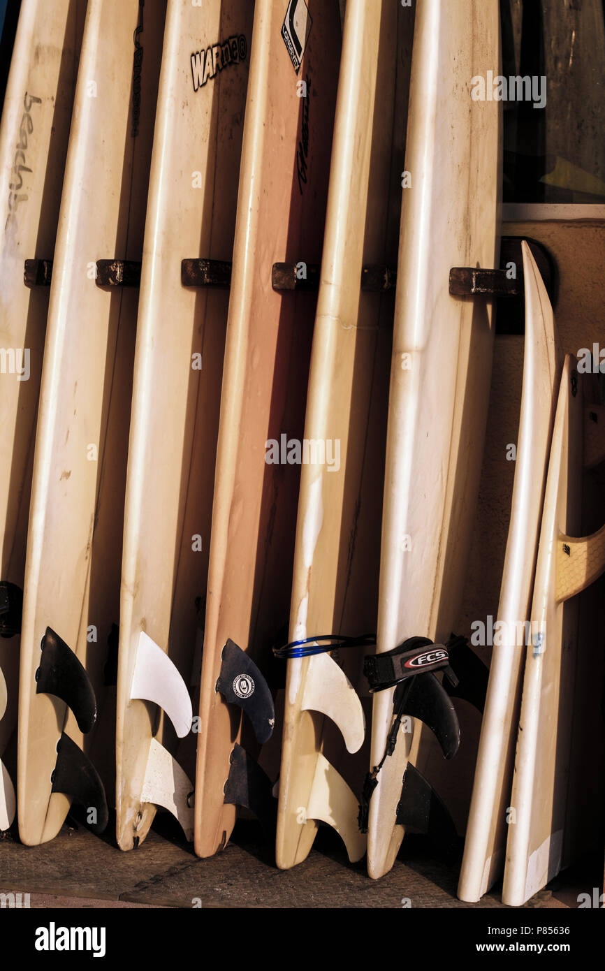 Old yellow surfboards for hire at Puerto Escondido, Mexico Stock Photo