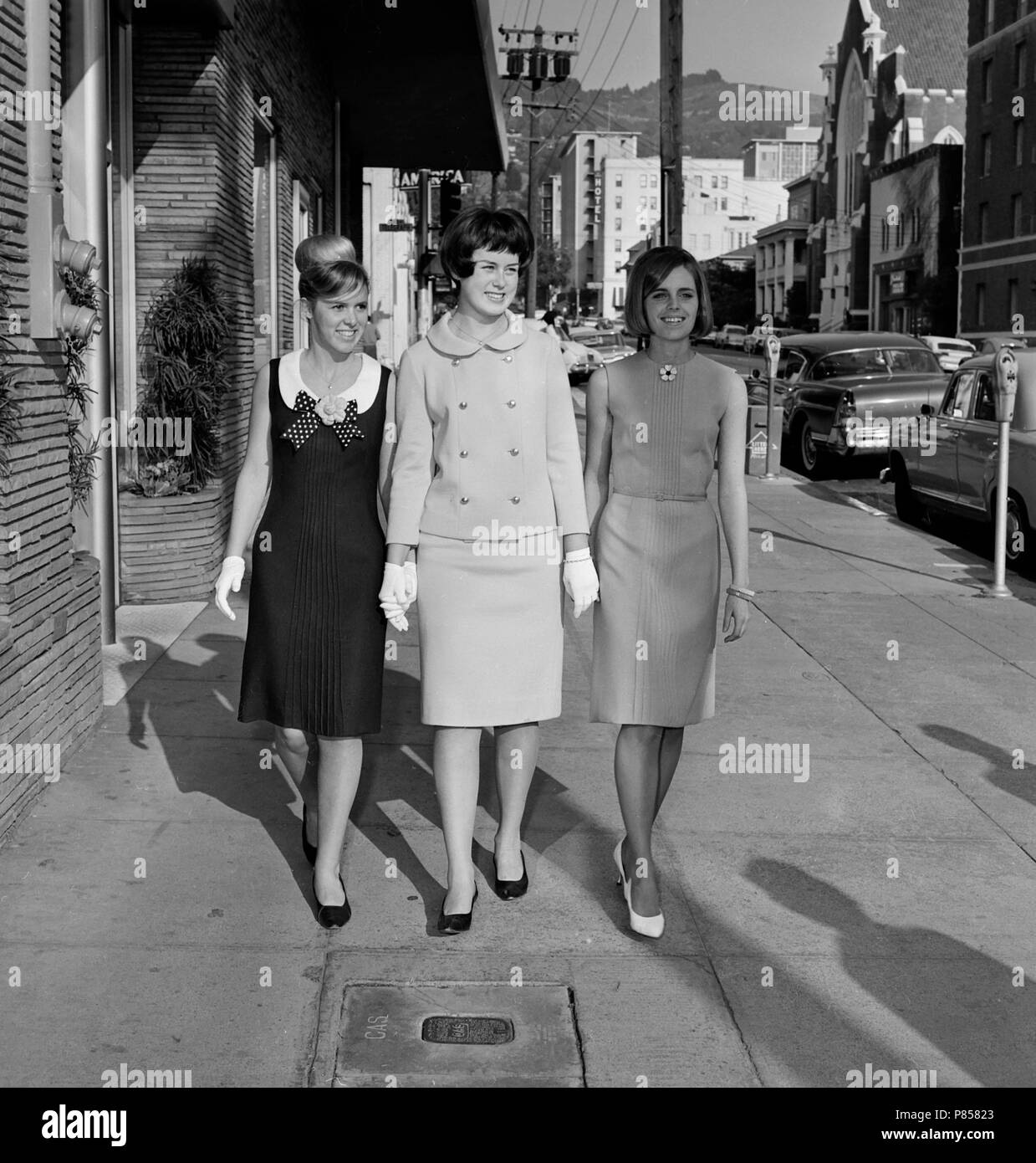 Teenage girls show off their fashion sense while strolling throughout Oakland, California, ca. 1965. Stock Photo