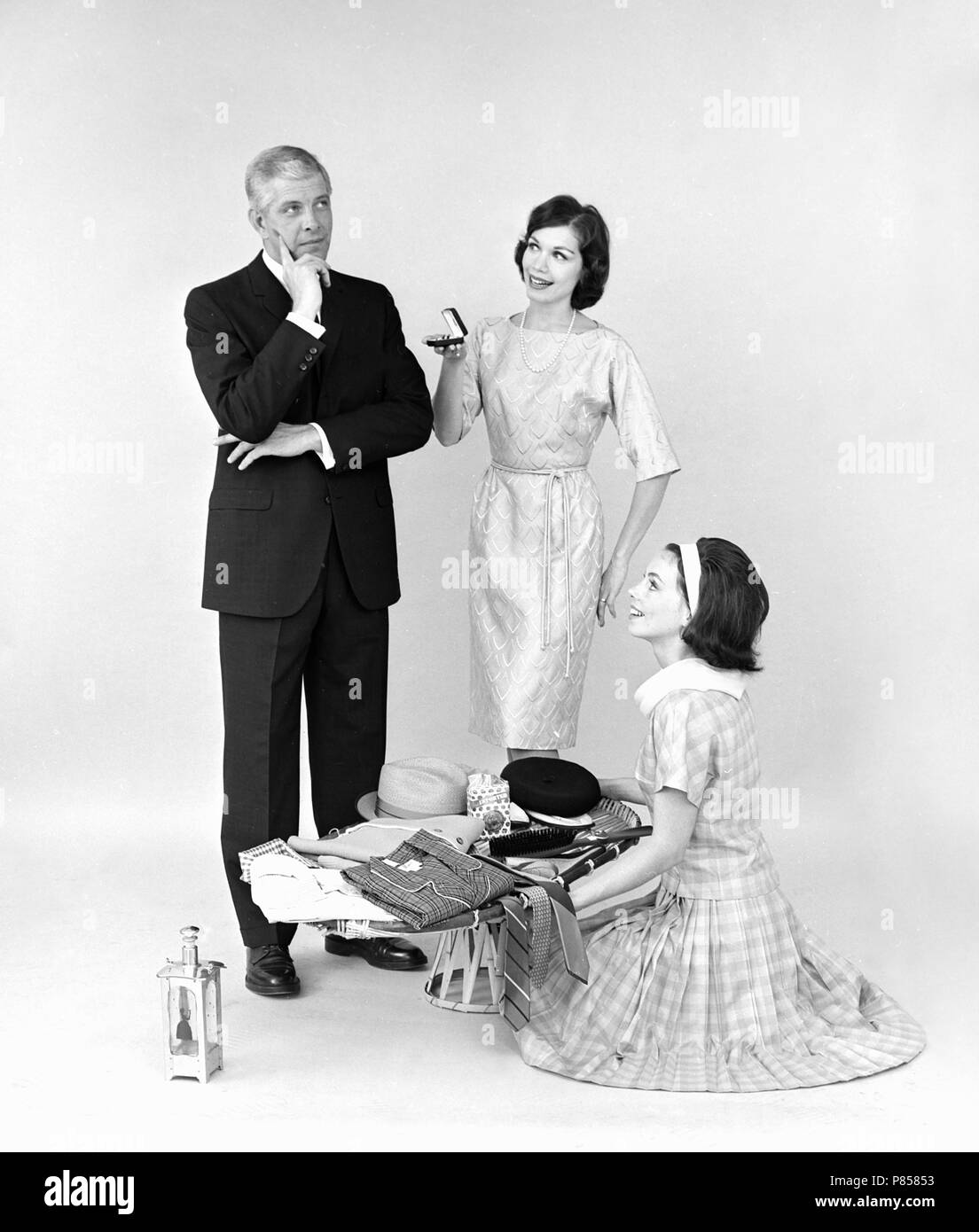 Mother and daughter contemplate gifts for Dad for Father’s Day, ca. 1963. Stock Photo