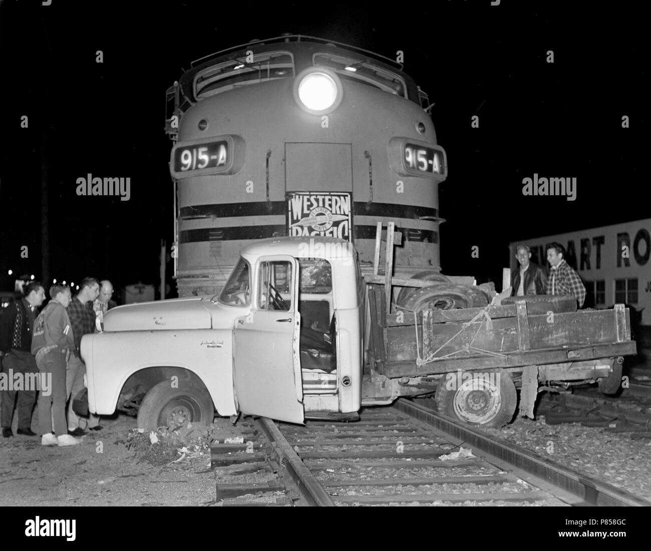 A Western Pacific locomotive wins a battle with a pickup truck at a California intersection, ca. 1962. Stock Photo