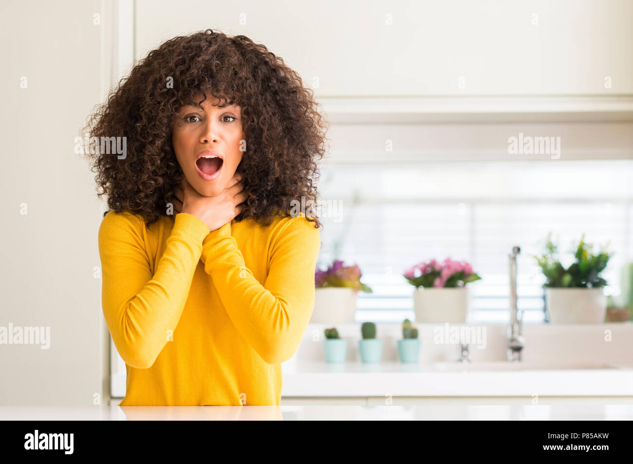 Woman choking kitchen hi-res stock photography and images - Alamy