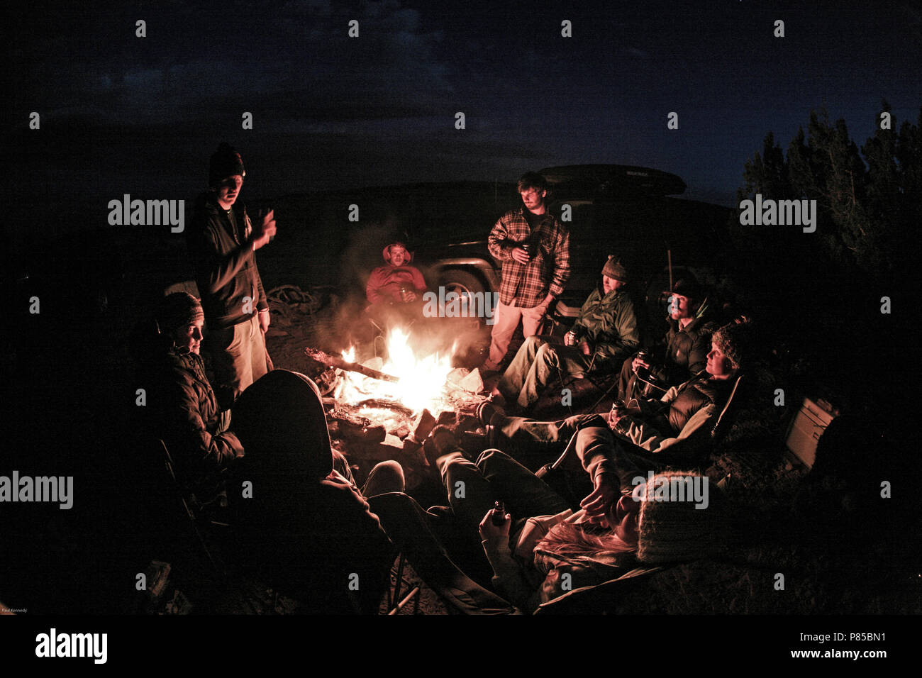 Group of friends sitting around a campfire in Moab, Utah, North America Stock Photo