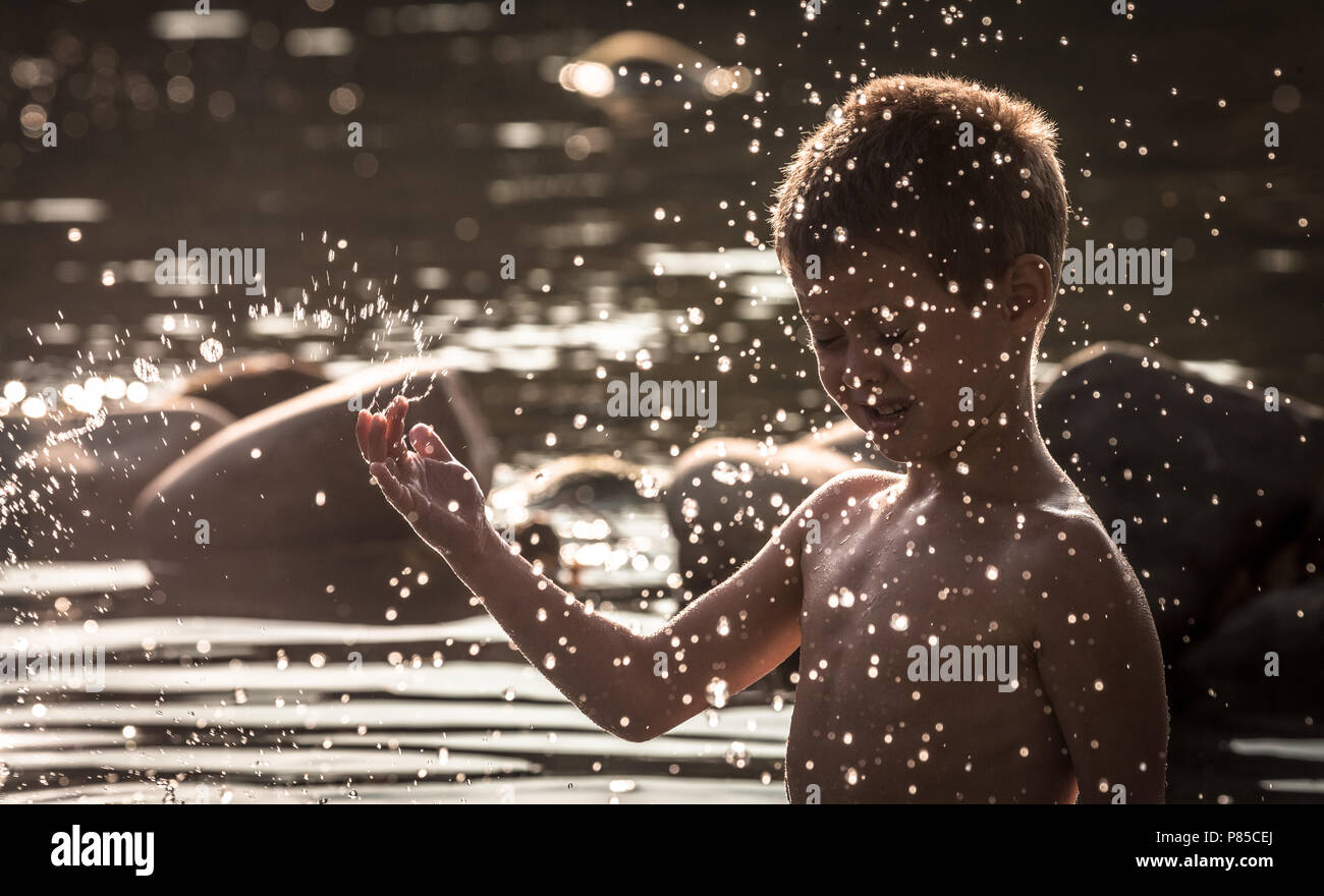 A boy is playing in the water. Stock Photo