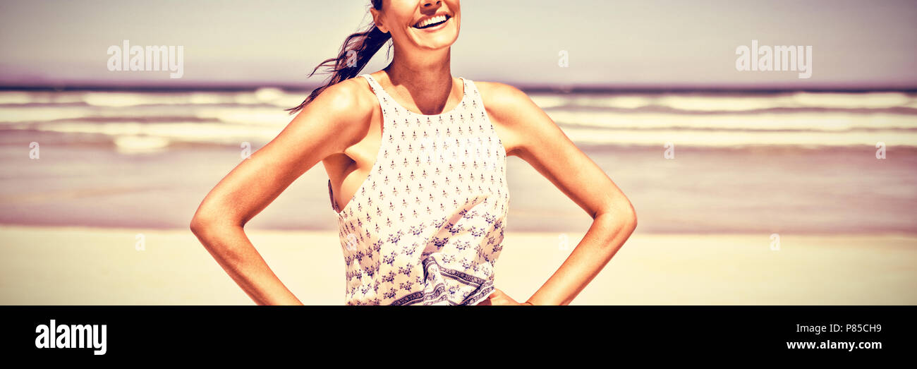 Portrait of smiling woman standing at beach Stock Photo
